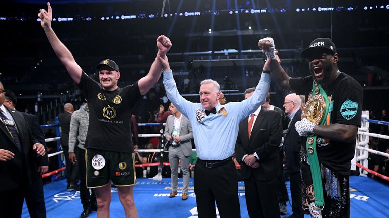 Tyson Fury and Deontay Wilder pose for a photo with referee Jack Reiss after fighting to a draw during the WBC Heavyweight Champioinship at Staples Center on December 1, 2018 in Los Angeles, California.  (Photo by Harry How/Getty Images)