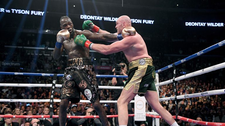 LDeontay Wilder and Tyson Fury punch each other in the ninth round fighting to a draw during the WBC Heavyweight Champioinship at Staples Center on December 1, 2018 in Los Angeles, California.  (Photo by Harry How/Getty Images)