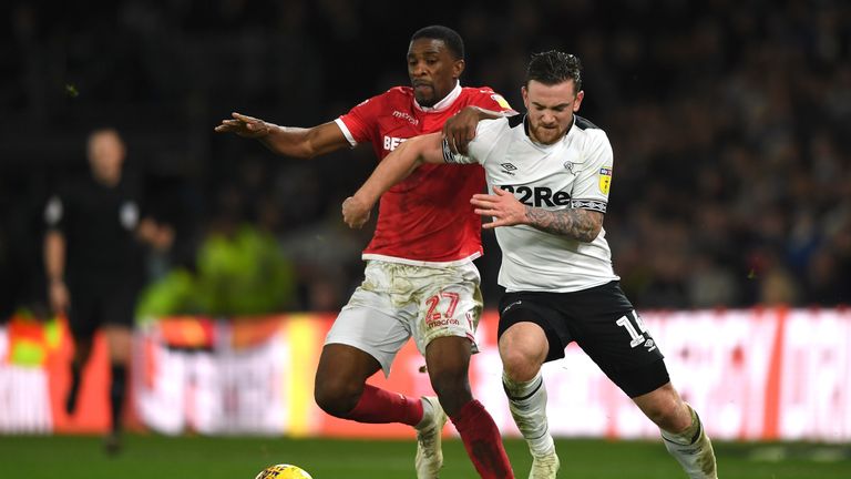 Jack Marriott of Derby County is challenged by Tendayi Darikwa of Nottingham Forest during the Sky Bet Championship match between Derby County and Nottingham Forest at Pride Park Stadium on December 17, 2018 in Derby, England.
