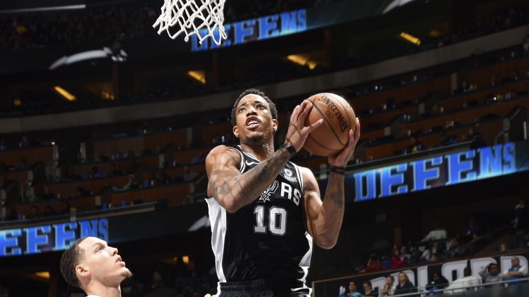 DeMar DeRozan of the San Antonio Spurs drives to the basket during the game against Aaron Gordon of the Orlando Magic