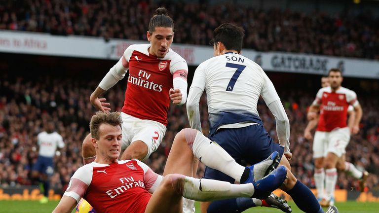 Heung-min Son goes down in the area following a challenge from Rob Holding