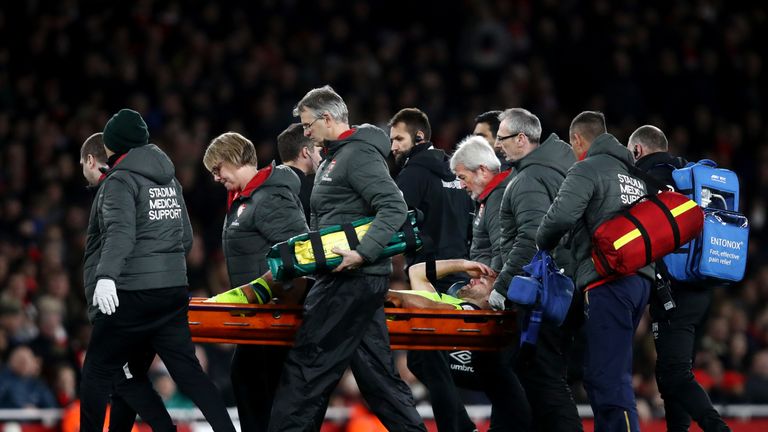 Tommy Smith is stretchered off during Huddersfield's defeat at Arsenal