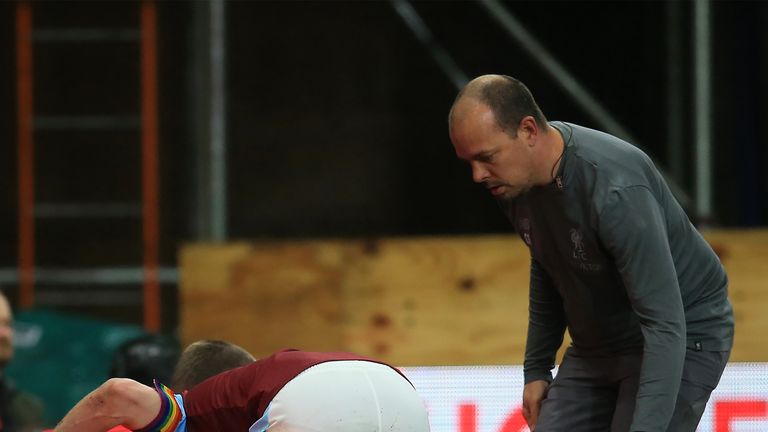 Joe Gomez lies injured on the touchline at Turf Moor