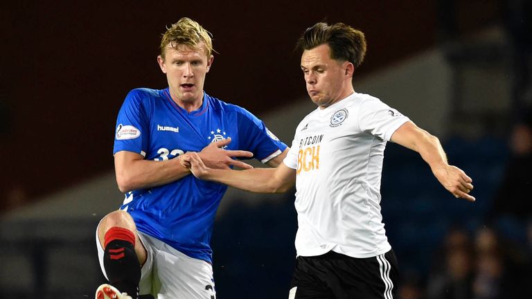 Rangers' Joe Worrall (L) in action with Ayr United's Lawrence Shankland.