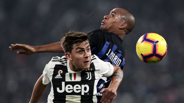Inter midfielder Joao Mario (R) jumps for the ball next to Juventus' Paulo Dybala