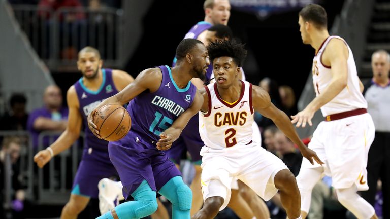 Kemba Walker of the Charlotte Hornets looks to pass around Collin Sexton of the Cleveland Cavaliers during their game at Spectrum Center