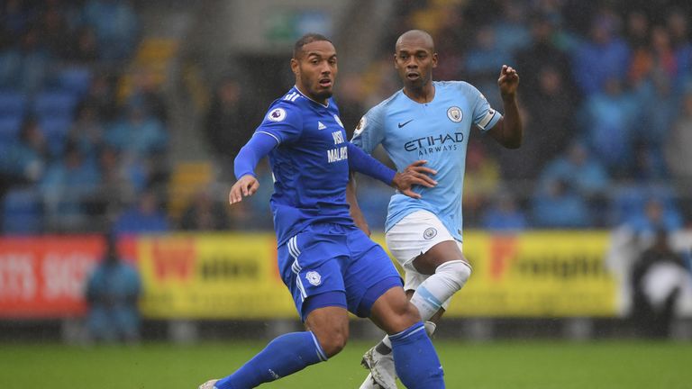 Manchester City player Fernandinho is challenged by Kenneth Zohore of Cardiff during the Premier League match between Cardiff City and Manchester City at Cardiff City Stadium on September 22, 2018 in Cardiff, United Kingdom. 
