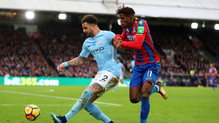 Manchester City's Kyle Walker grapples with Crystal Palace's Wilfried Zaha