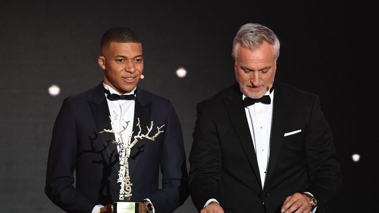 Kylian Mbappe receives his award at the Ballon d'Or ceremony in Paris