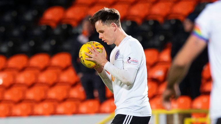 Ayr United&#39;s Lawrence Shankland collects the match-ball at full-time.