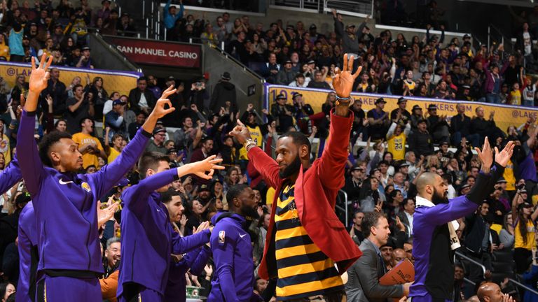 LeBron James celebrates the Lakers' win from the sidelines                                                            