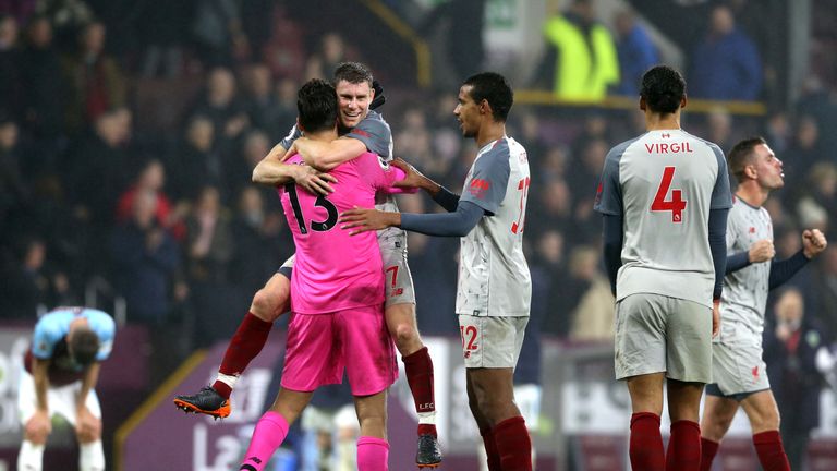 Alisson and James Milner celebrate as Liverpool stay 2 points behind leaders Manchester City