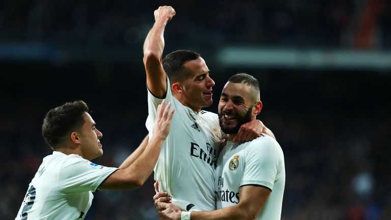 Lucas Vazquez of Real Madrid (C) celebrates after scoring his team's second goal with Karim Benzema (R) and Sergio Reguilon (L) during the La Liga match between Real Madrid CF and Valencia CF at Estadio Santiago Bernabeu on December 01, 2018 in Madrid, Spain.