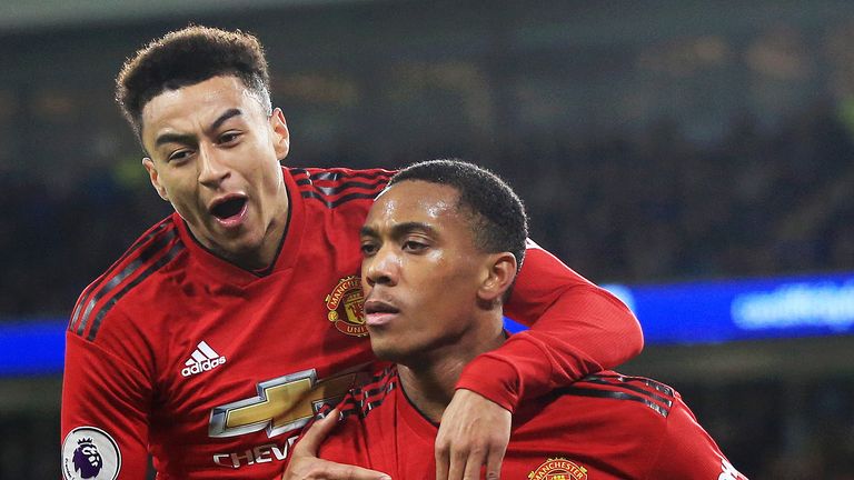 Anthony Martial of Manchester United celebrates scoring thier 3rd goal with Jesse Lingard during the Premier League match between Cardiff City and Manchester United at Cardiff City Stadium on December 22, 2018 in Cardiff, United Kingdom.