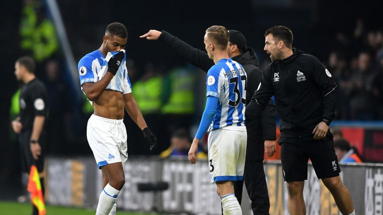 Steve Mounie leaves the field after seeing red during the Premier League match between Huddersfield Town and Brighton.