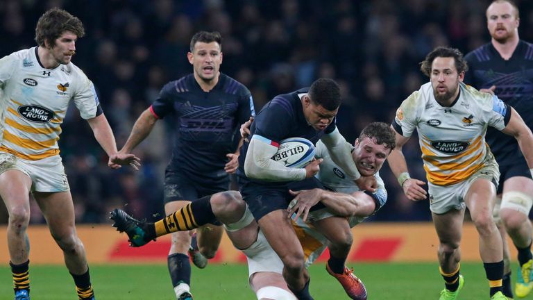 Nathan Earle of Harlequins is tackled by Will Rowlands of Wasps