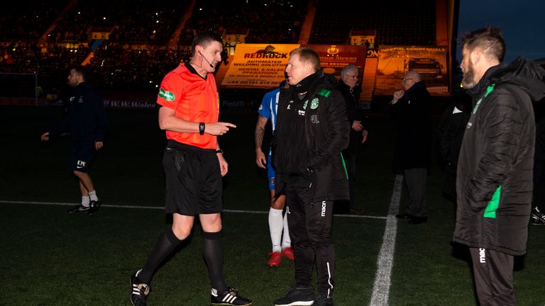 Hibs Manager Neil Lennon with referee Craig Thomson following a floodlight failure