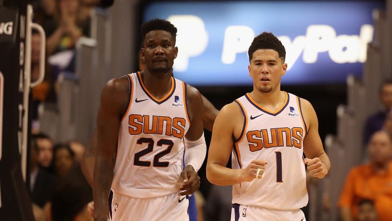 Devin Booker #1 and Deandre Ayton #22 of the Phoenix Suns during the NBA game against the Dallas Mavericks at Talking Stick Resort Arena on October 17, 2018 in Phoenix, Arizona. The Suns defeated defeated the Mavericks 121-100.
