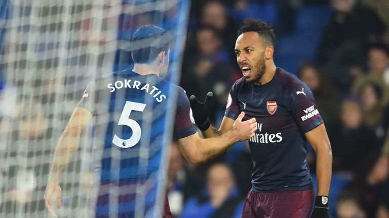 Arsenal's Gabonese striker Pierre-Emerick Aubameyang (R) celebrates scoring the opening goal during the English Premier League football match between Brighton and Hove Albion and Arsenal at the American Express Community Stadium in Brighton, southern England on December 26, 2018