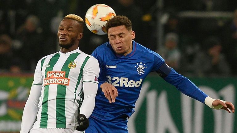 Rapid Wien's Belgian defender Boli Bolingoli Mbombo and Glasgow Rangers' English defender James Tavernier (R) vie for the ball during the UEFA Europa League Group G football match between Rapid Wien and Glasgow Rangers on December 13, 2018 in Vienna.