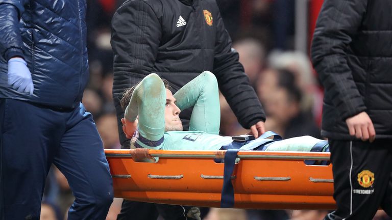 Rob Holding is stretchered off at Old Trafford