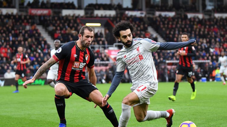 Liverpool&#39;s Mohamed Salah is challenged by Bournemouth defender Steve Cook