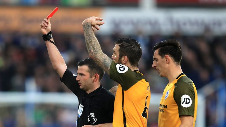 Referee Michael Oliver shows Steve Mounie of Huddersfield Town (not pictured) a red card during the Premier League match between Huddersfield Town and Brighton & Hove Albion at John Smith&#39;s Stadium on December 1, 2018 in Huddersfield, United Kingdom. 