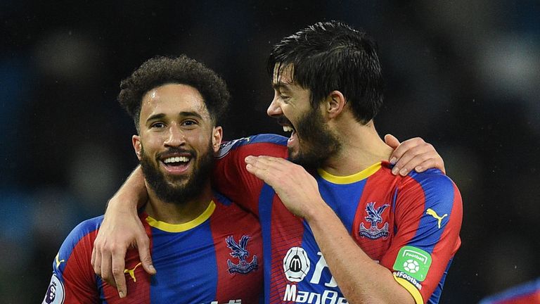 Crystal Palace's English midfielder Andros Townsend (L) and Crystal Palace's English defender James Tomkins (R) celebrate after the final whistle during the English Premier League football match between Manchester City and Crystal Palace at the Etihad Stadium in Manchester, north west England, on December 22, 2018.