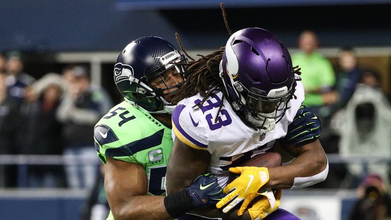 SEATTLE, WA - DECEMBER 10: Dalvin Cook #33 of the Minnesota Vikings is tackled by Bobby Wagner #54 of the Seattle Seahawks in the first quarter at CenturyLink Field on December 10, 2018 in Seattle, Washington. (Photo by Abbie Parr/Getty Images)