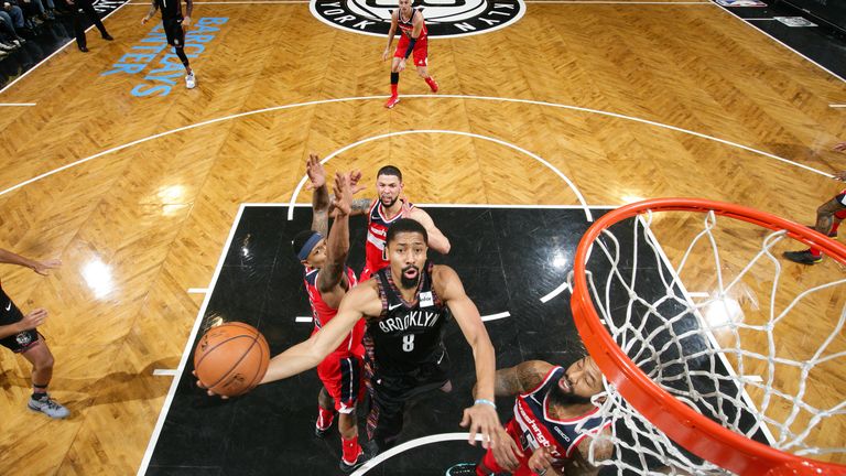 Spencer Dinwiddie finishes at the rim against Washington