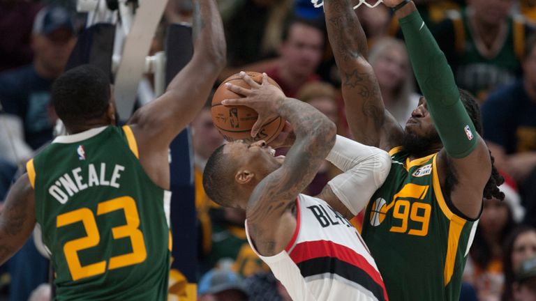 Damian Lillard is crowded out to Royce O'Neale and Jae Crowder