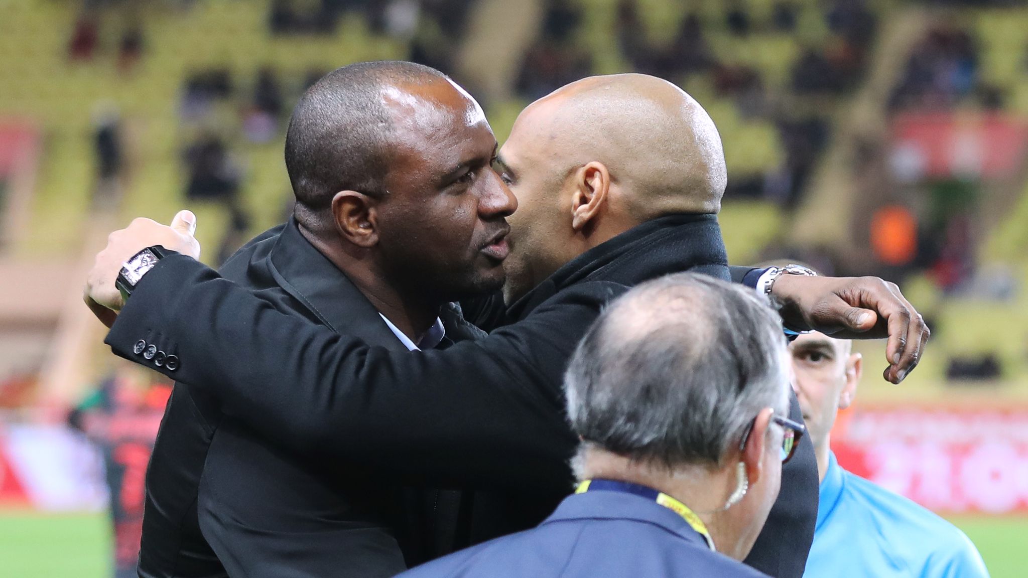  A photo of Thierry Henry and Patrick Vieira embracing after a soccer match.