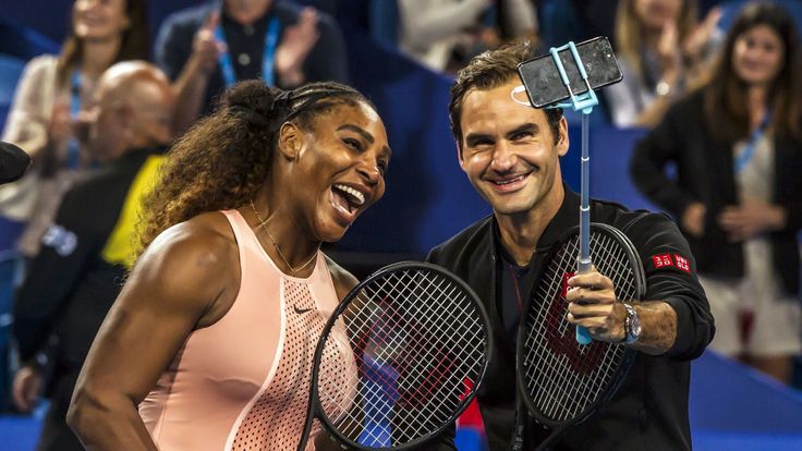 Serena Williams of the US (L) and Roger Federer of Switzerland (R) take a selfie following their mixed doubles match on day four of the Hopman Cup tennis tournament in Perth January 1, 2019. (