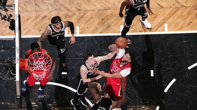 Anthony Davis battles to get off a shot in the paint against Brooklyn