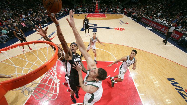 Bradley Beal finishes at the rim against Milwaukee