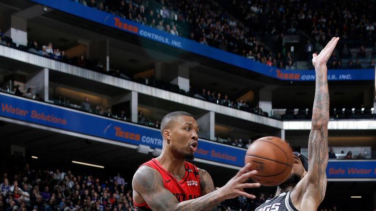 Damian Lillard throws a pass against Sacramento