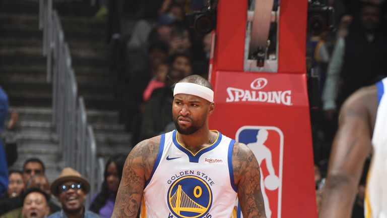 DeMarcus Cousins offers a trademark sneer following an emphatic dunk on debut for Golden State