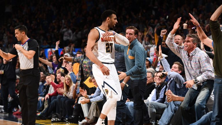 Jamal Murray high-fives with Nuggets fans after hitting a half-court shot