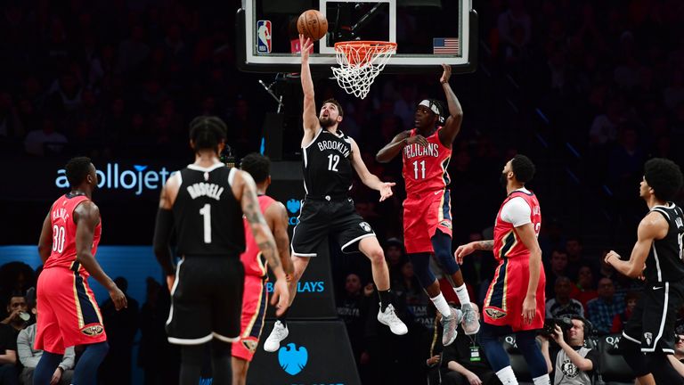 Joe Harris scores with a lay-up against New Orleans