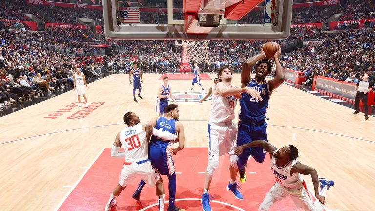 Joel Embiid absorbs contact to score in the paint