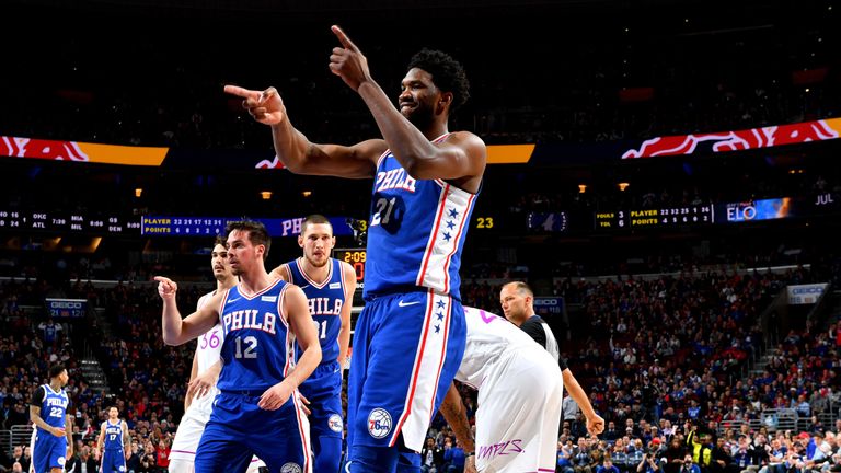 Joel Embiid salutes the crowd after scoring against Minnesota