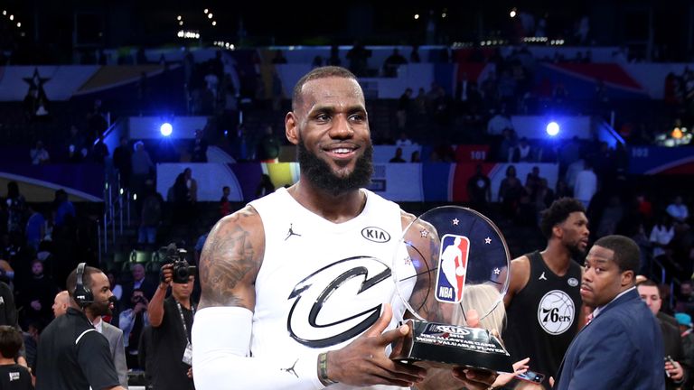 LeBron James poses with his MVP award at the 2108 All-Star game
