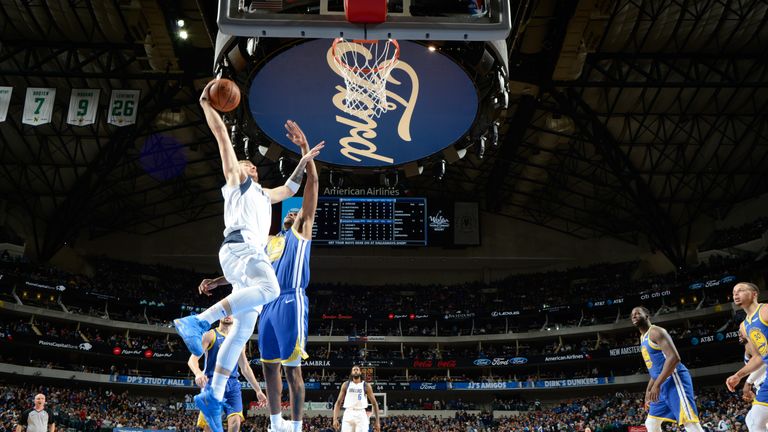 Luka Doncic skies for a dunk on Kevon Looney