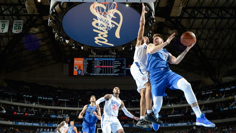 Luka Doncic throws a pass whilst airborne against the Los Angeles Clippers
