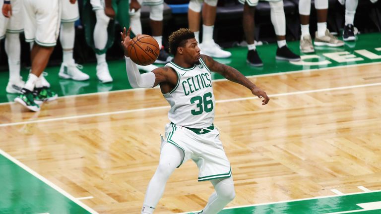 Marcus Smart jumps to hold the ball in the game