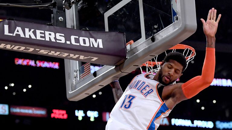 Paul George scores with a dunk against the Los Angeles Lakers