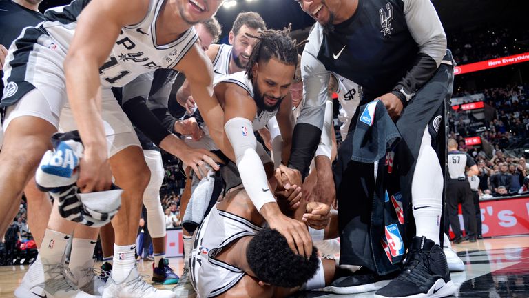 Rudy Gay is mobbed by his Spurs team-mates after hitting the game-winning shot against Phoenix