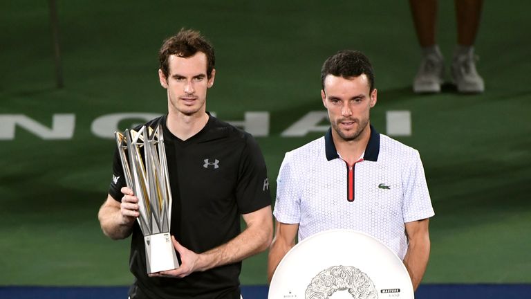 Andy Murray (L) of Britain holds his trophy after winning his men's singles finals match next to runner's up Roberto Bautista Agut of Spain at the Shanghai Masters tennis tournament in Shanghai on October 16, 2016