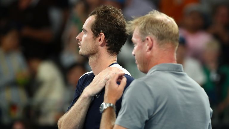 Murray and his former coach Mark Petchey, who interviewed him post-match, watch on as a montage of tributes from fellow players is shown