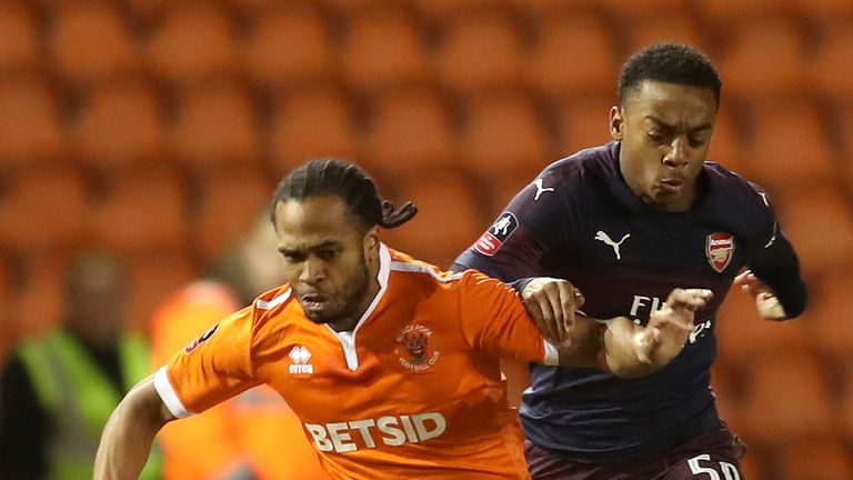 Nathan Delfouneso is challenged by Joe Willock
